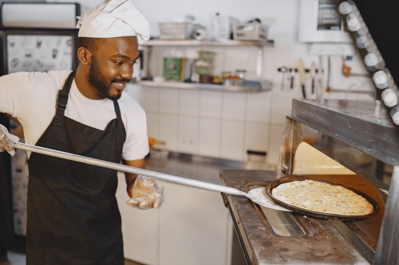 Pizza factory kitchen interior showing handcrafted pizza making